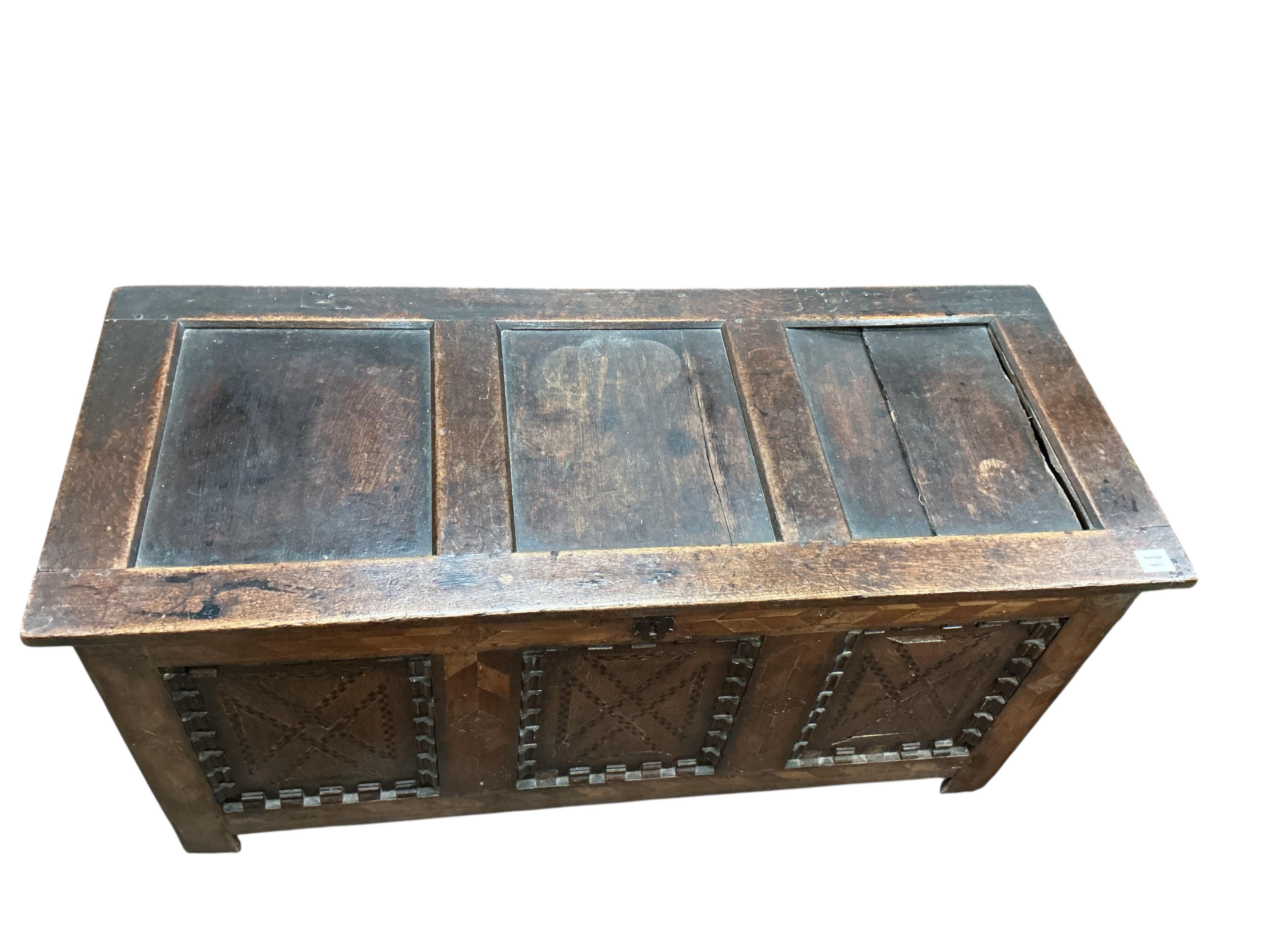 An early 18th century parquetry inlaid panelled oak coffer, width 131cm, depth 54cm, height 64cm